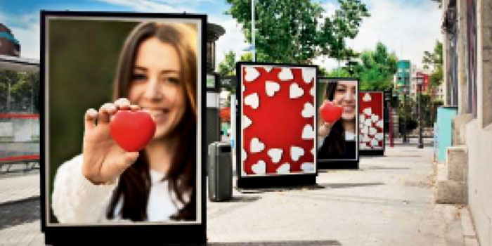 outdoor billboards showing a women holding an apple