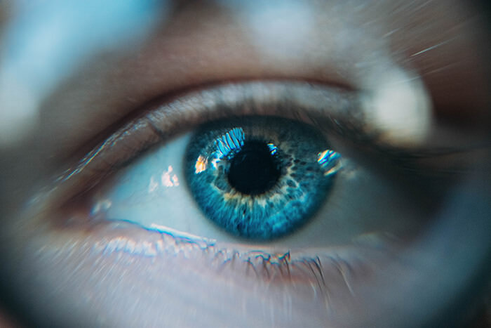 close up of an eye with blue lens